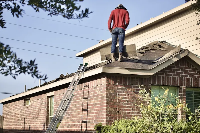 Professional roofer working on a residential roof in Northwoods